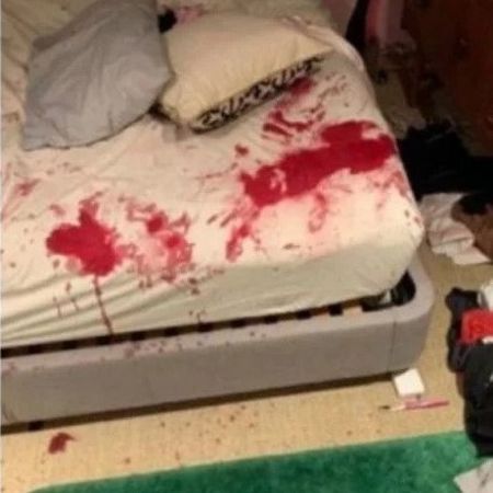 The bloody bed sheet covered mostly with Flack's blood